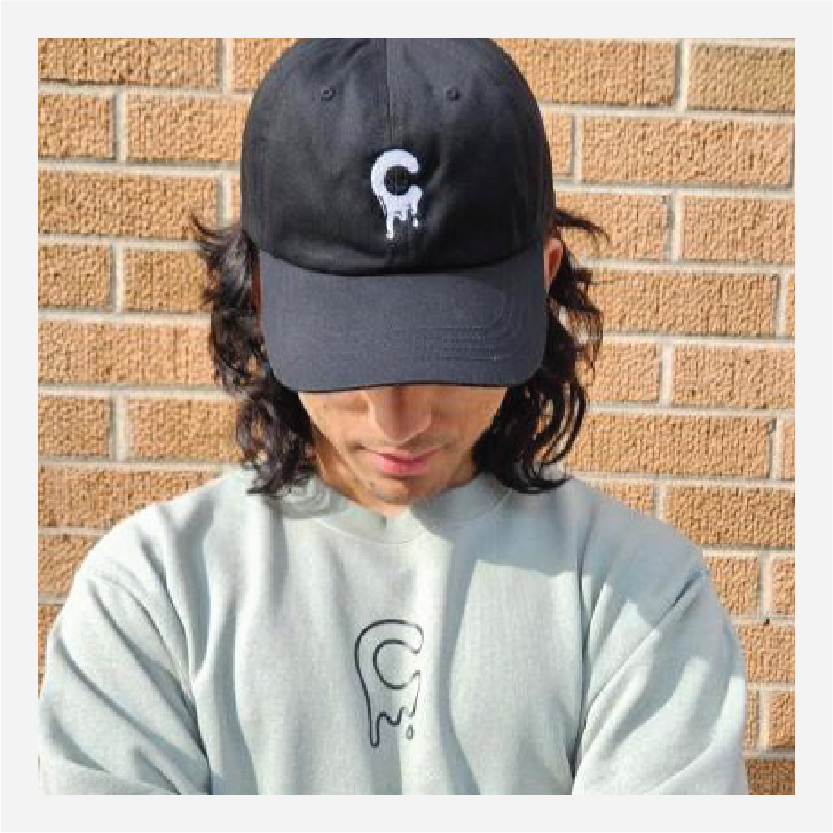 mCream Merch - Model playfully holding mCream products