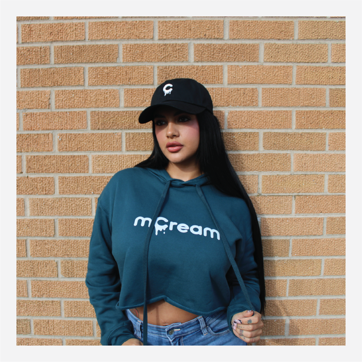 mCream Merch - Model holding mCream product pouch